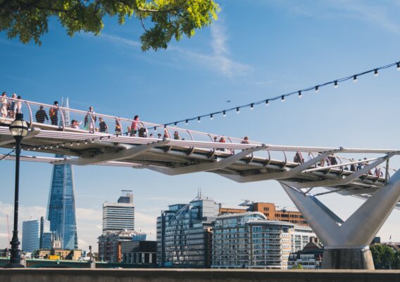 People walking over a bridge.