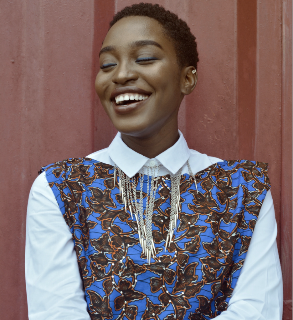 Woman with bright blue shirt smiling widely